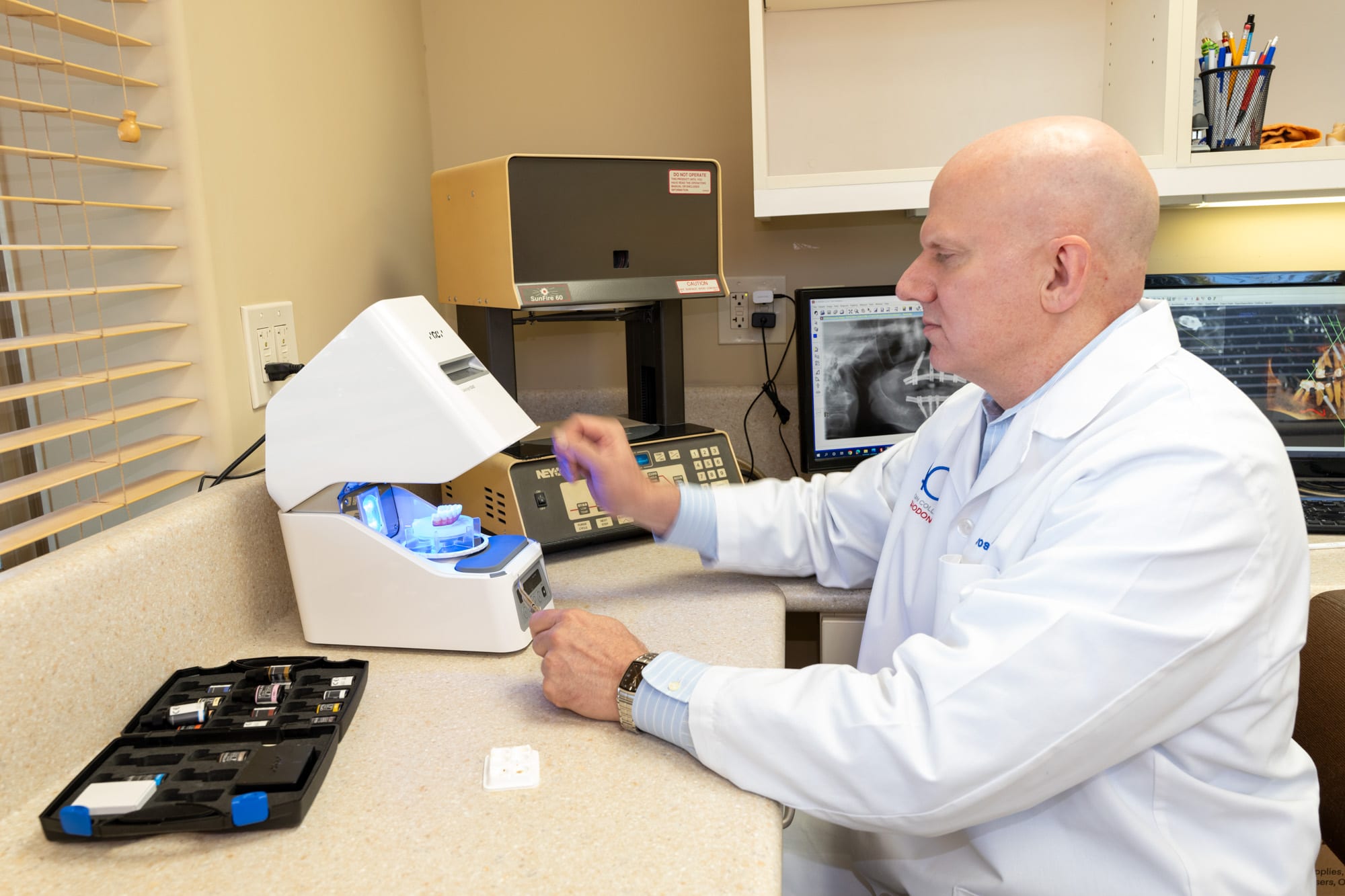 Dr. Andrus working at the in-office ceramic firing oven, used to fabricate strong, lifelike denture and crown restorations