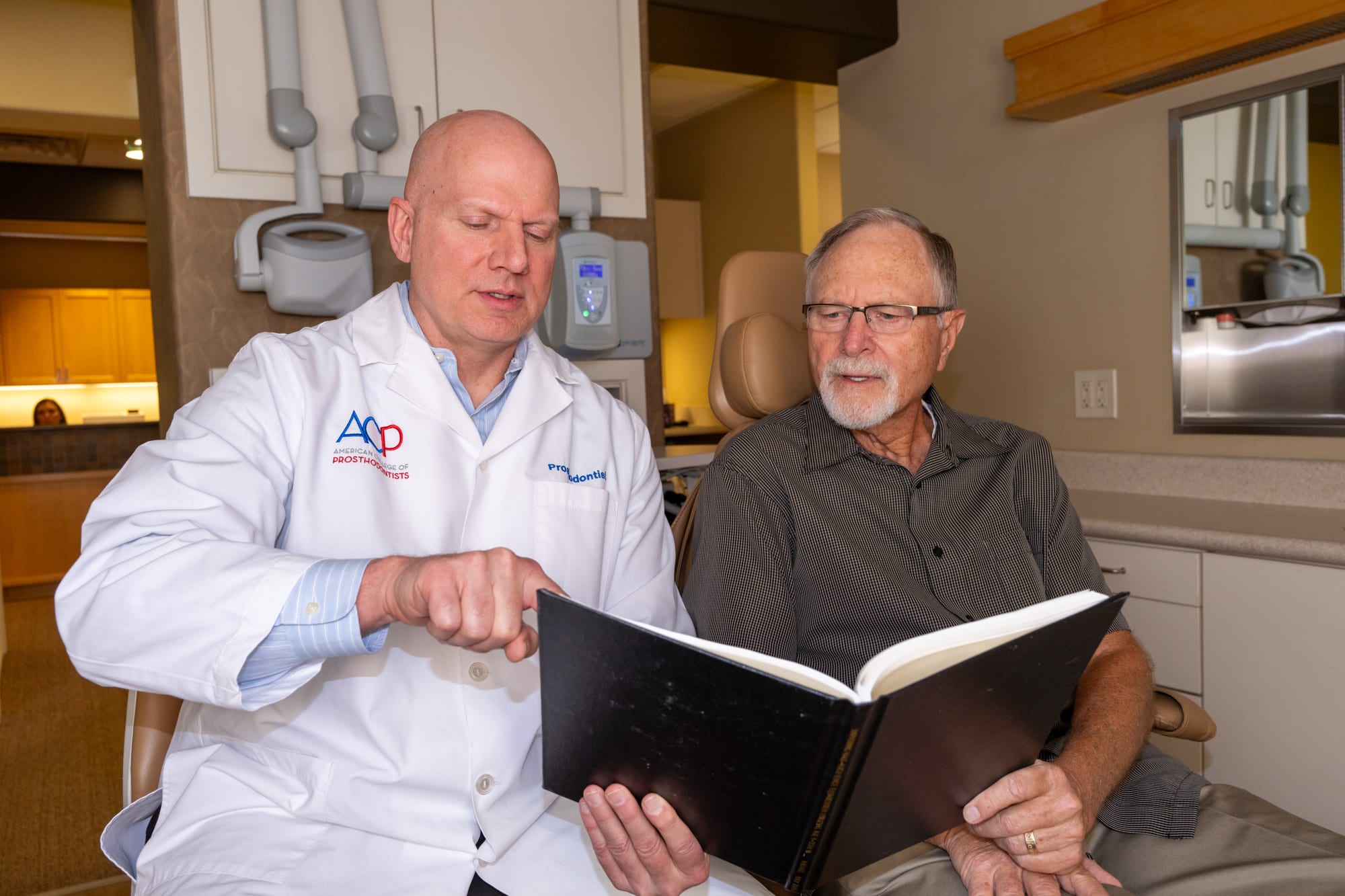 Dr. Andrus reviewing treatment options chairside with a patient